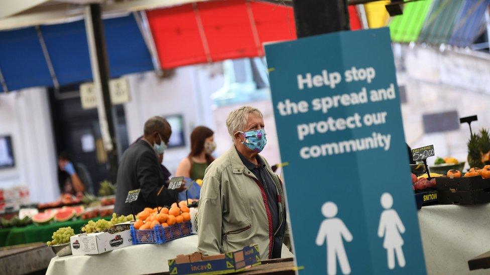 People wearing face masks at a market