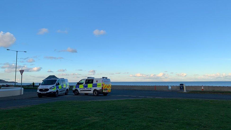 Police vans by the cordon