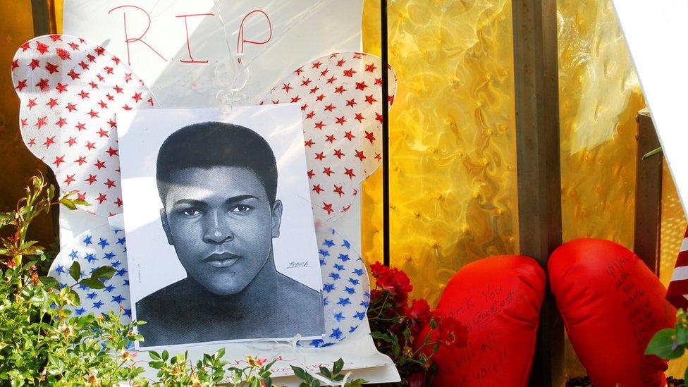 Fans of Muhammad Ali leave pictures and personal mementos as they pay their respects at the Ali Center in Louisville on 6 June