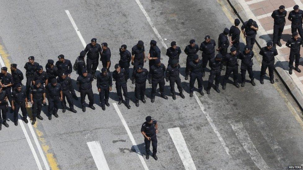 Police block a road ahead of a protest organised in Malaysia's capital city Kuala Lumpur