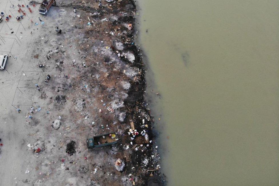 In this aerial photograph taken on May 5, 2021 funeral pyres of Covid-19 coronavirus victims are seen in a cremation ground along the banks of the Ganges River, in Garhmukteshwar