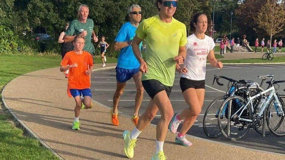 Lewis running with other Parkrunners