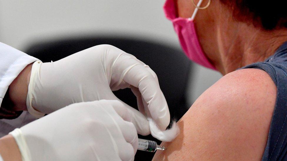 A woman receives a dose of the Chinese Sinopharm vaccine against COVID-19 during a mass vaccination campaign at the Boris Trajkovski Arena in Skopje, Republic of North Macedonia, 05 May 2021.