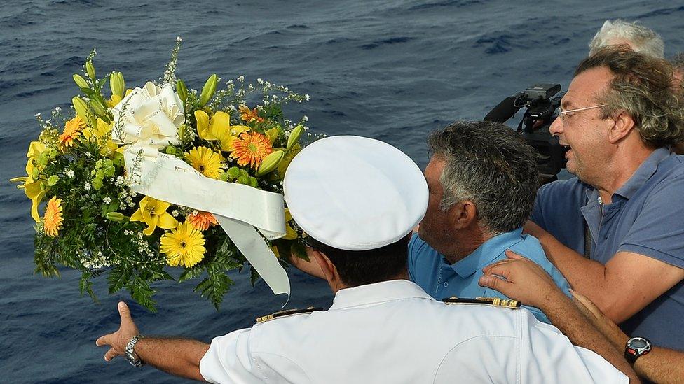 Fishermen lay a wreath in memory of victims of the Lampedusa disaster