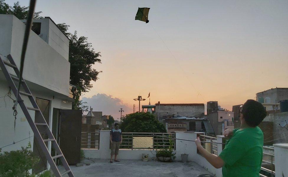 A child flying a kite in Delhi