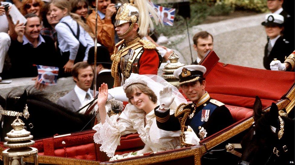 The Prince and Princess of Wales wave in an open-top carriage on their wedding day