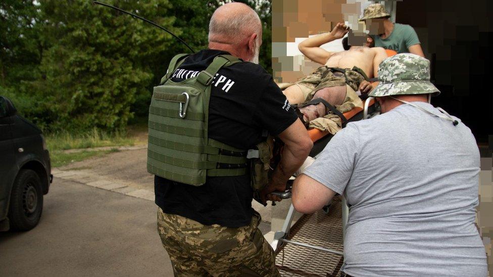 Surgeon injured by a landmine being carried on a stretcher