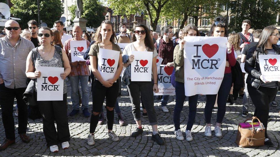 People gather ahead of a vigil in Albert Square, Manchester