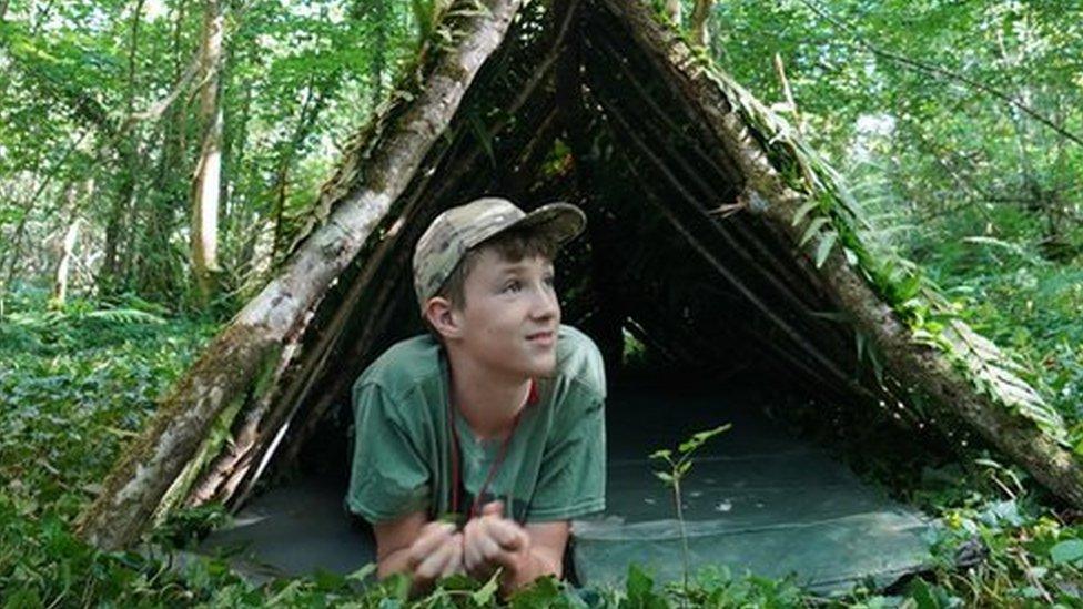 Max lies under woodland shelter and cover