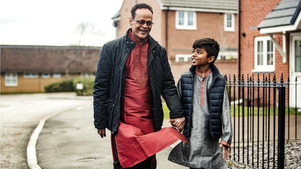 Muslim boy and his grandfather in street