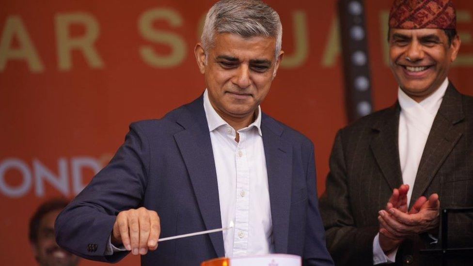 Sadiq Khan lighting a candle during the Diwali celebration on Trafalgar Square