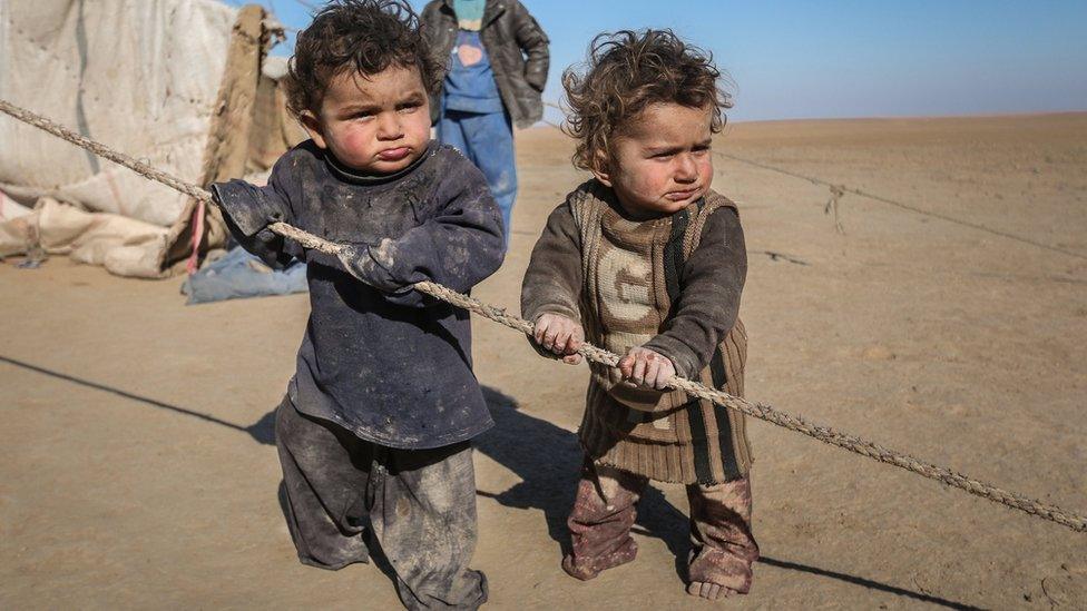 Internally displaced Syrian children who fled Raqqa city stand near their tent in Ras al-Ain province, Syria January 22, 2017