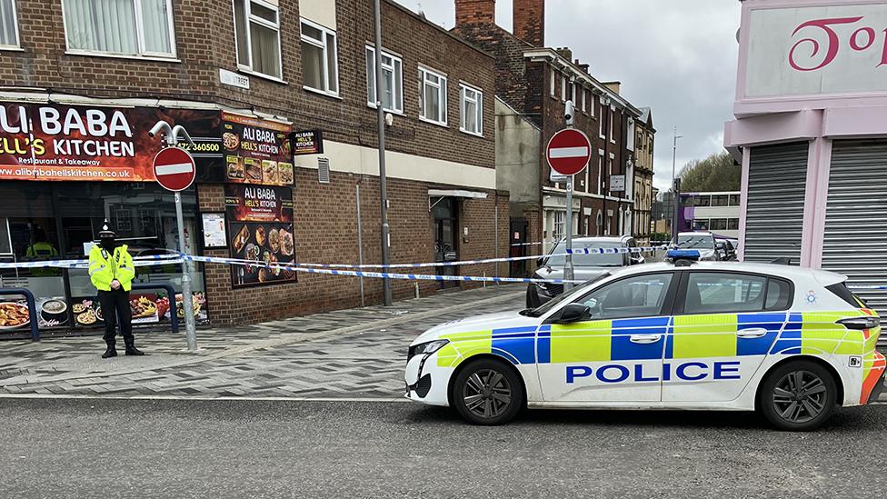 Police officer and car at the scene