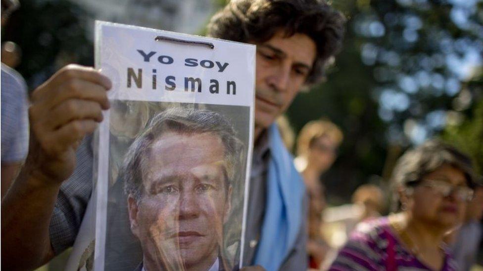 In this 18 March, 2015 file photo, a demonstrator holds a photo of late prosecutor Alberto Nisman that reads in Spanish "I am Nisman" at an protest outside a court house demanding justice, two months after his death in Buenos Aires, Argentina