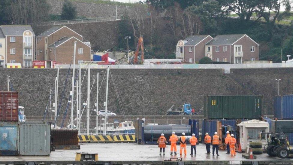 Workers hold minutes silence