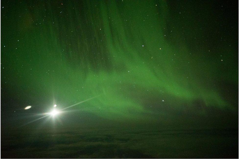 A shot of the aurora, glowing green with the moon as a blazing point of light, 60 degrees south of equator. Night of Thursday 23 March 2017.