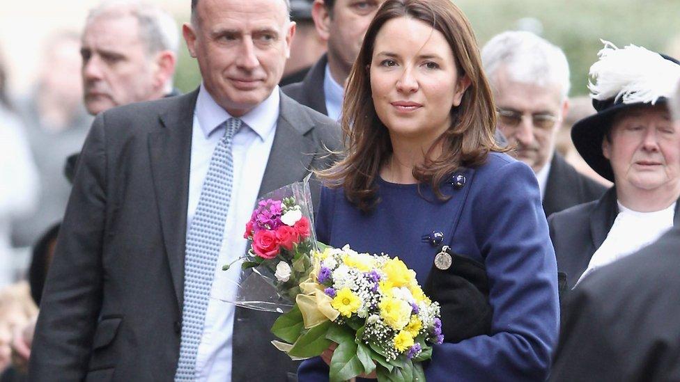 Rebecca Deacon holding flowers for the duchess on a public engagement in 2012