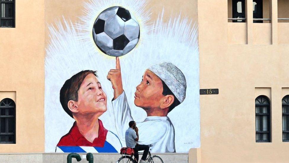 A mural of children and a football in Qatar