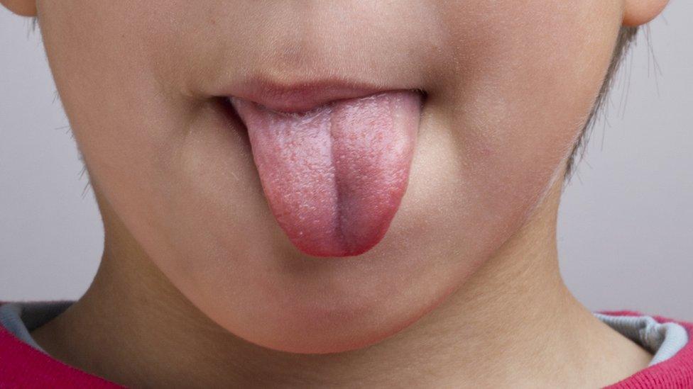 Boy sticking tongue out