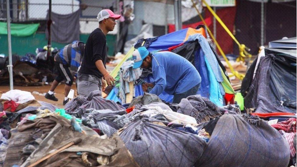 People pick their belongings at the Benito Juarez shelter in Tijuana, Baja California, Mexico, 1 December 2018.