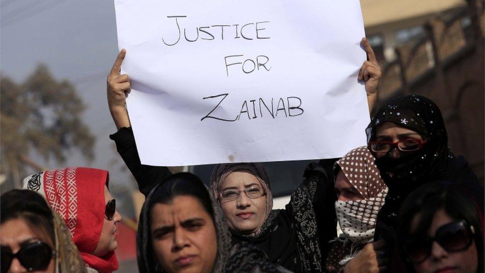 Women demonstrate, holding a sign saying Justice For Zainab, in Kasur, Pakistan