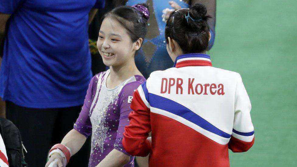 South Korea"s Lee Eun-ju, left, smiles as she talks with North Korea"s Hong Un Jong during the artistic gymnastics women"s qualification at the 2016 Summer Olympics in Rio de Janeiro, Brazil, Sunday, Aug. 7, 2016.