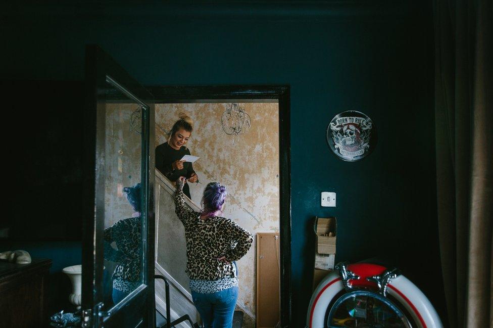 Melanie Semple chats with her daughter in the hallway of her home in Newcastle