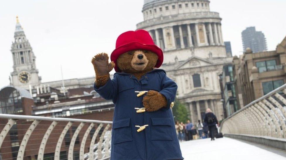 epa06772677 Paddington Bear poses for photographs on Millennium Bridge in front of St Paul"s Cathedral in Central London, Britain, 30 May 2018. The photocall marked the launch of late British author Michael Bond"s final book, titled Paddington at St Paul"s". EPA/WILL OLIVER