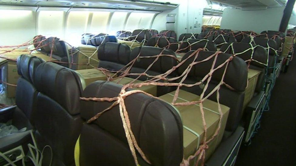 PPE in boxes strapped into plane seats