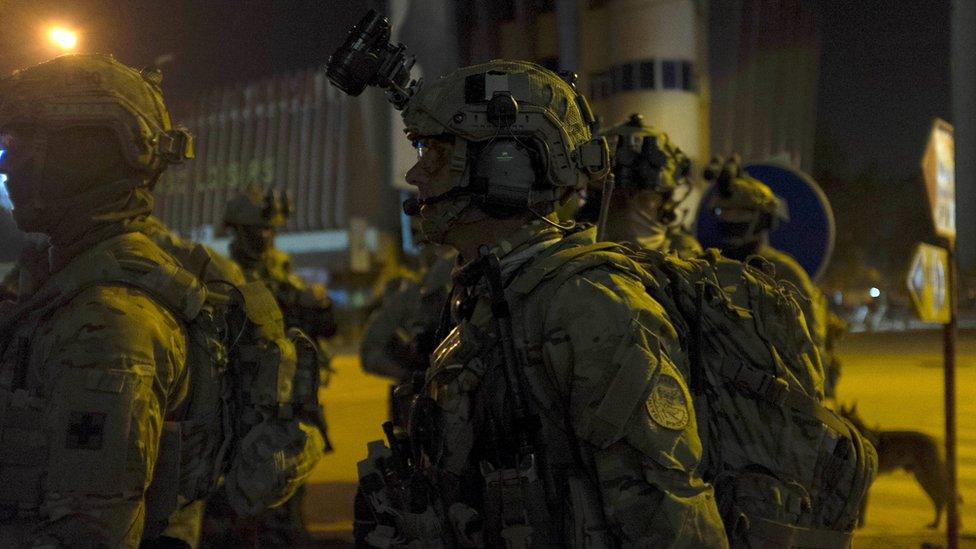 French and US soldiers gather before launching a counter-assault on Islamist gunmen at the Splendid Hotel in Ouagadougou