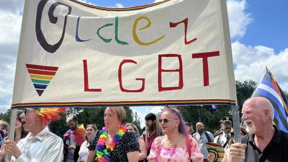 People with an LGBT Pride banner