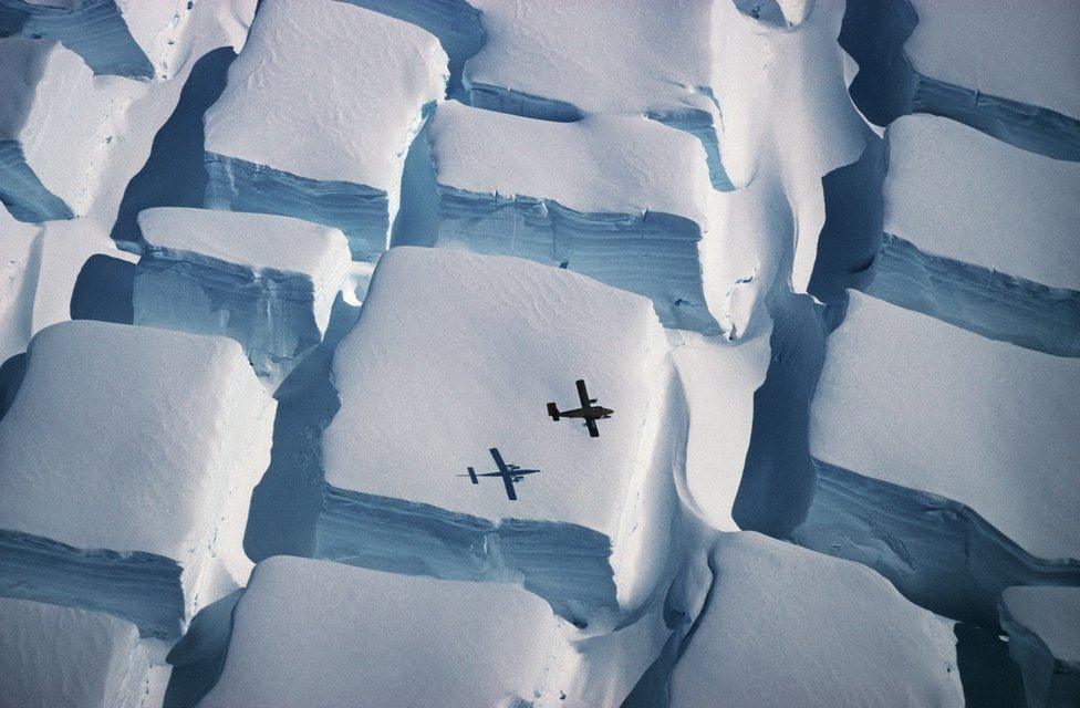 Plane and its shadow with ice below