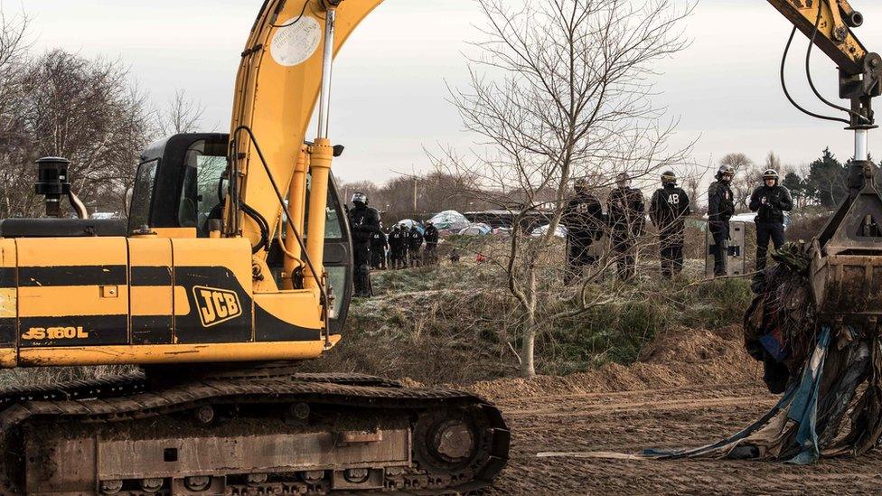 Bulldozer clears part of the makeshift Calais camp called the "Jungle"