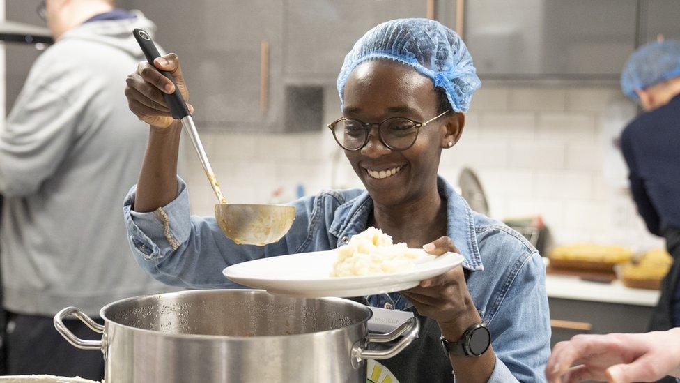 A volunteer dishing up at FoodCycle Wolverhampton