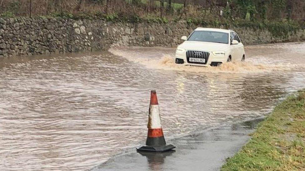 Car driving through flooded road