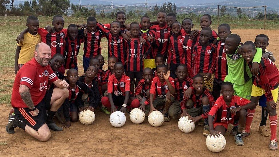 Coach Dave Sparham with youngsters wearing Gala Fairydean Rovers and Tweedbank Thistle tops.