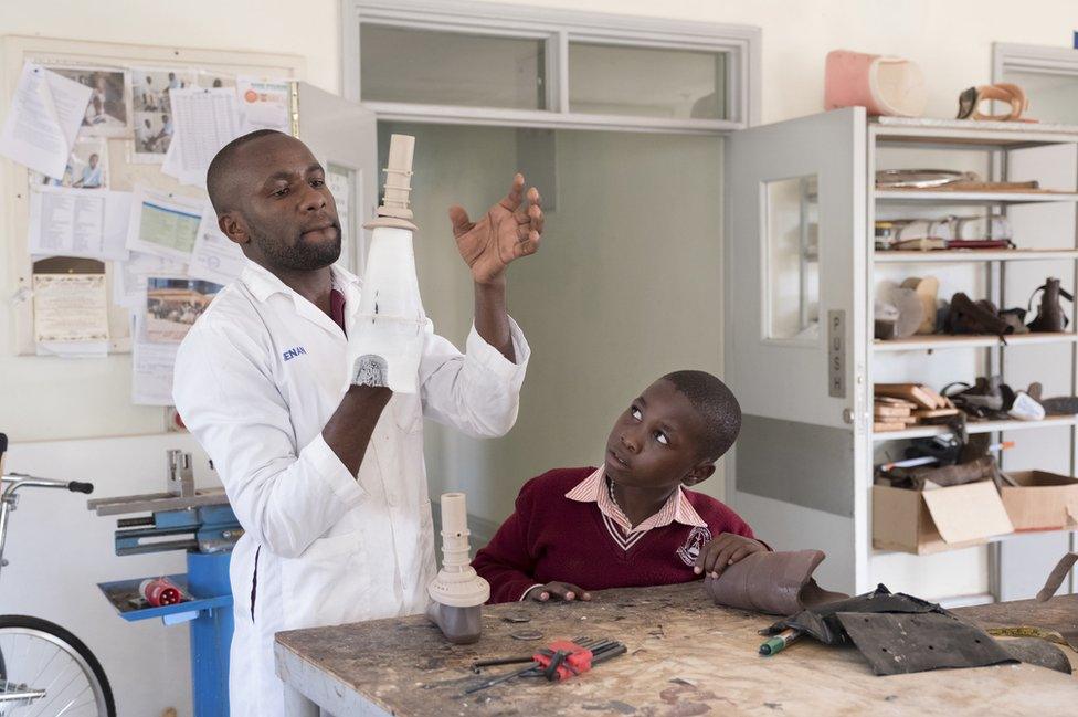 A doctor holds a 3D printed socket.