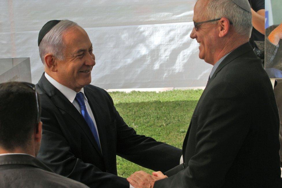 Benjamin Netanyahu (L) shakes hands with Benny Gantz at Mount Herzl in Jerusalem on 19 September 2019