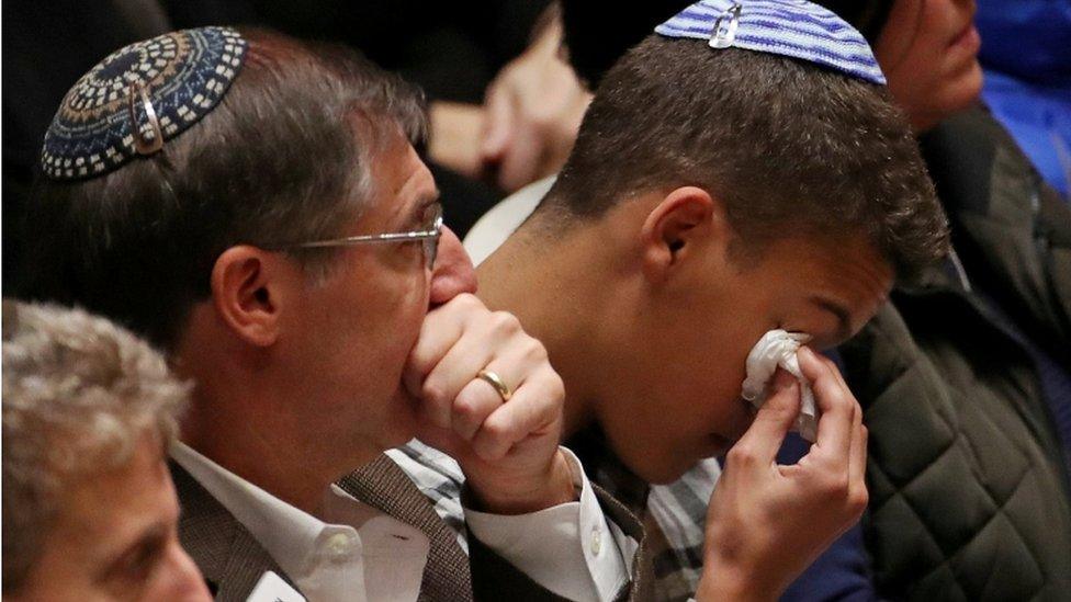 Mourners crying during the memorial service