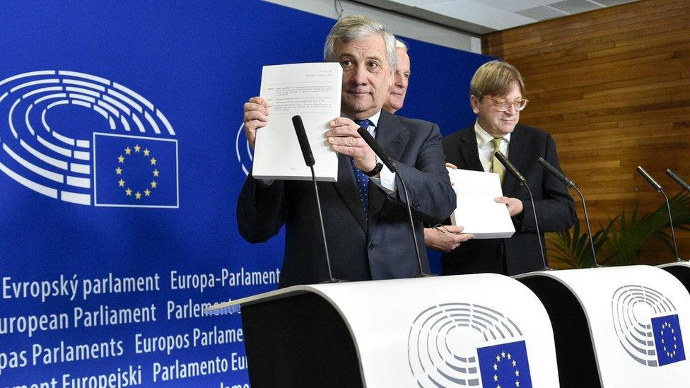 European Parliament President Antonio Tajani holds up a copy of the Brexit withdrawal agreement