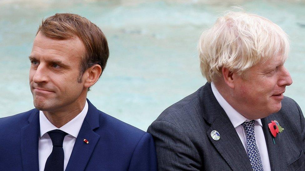 Prime Minister Boris Johnson and French President Emmanuel Macron look on in front of the Trevi Fountain during the G20 summit in Rome