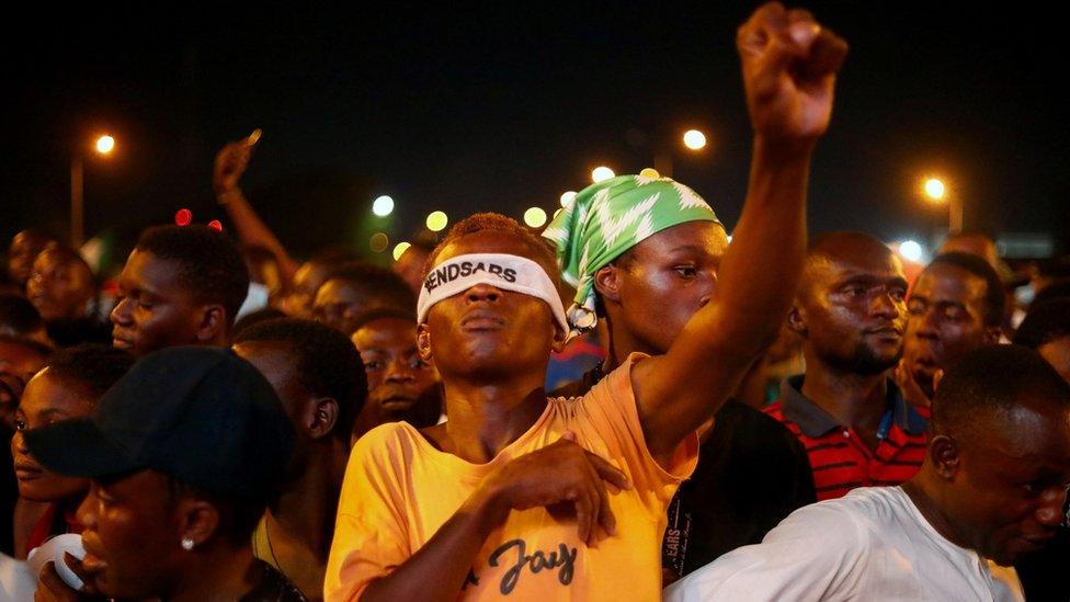 A demonstrator wearing a blindfold with an inscription "End Sars", gestures during protest against alleged police brutality in Lagos, Nigeria October 17, 2020. Picture taken October 17, 2020. REUTERS/Temilade Adelaja