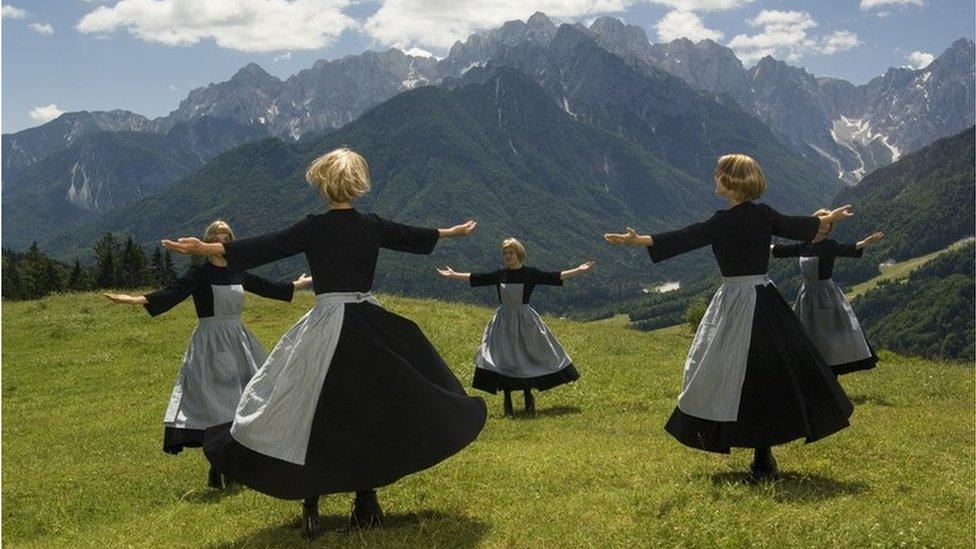 Women dressed as Maria dance on the Austrain mountain