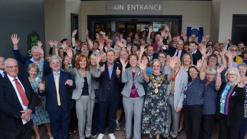 Large group of people, including Harry and Sandra Redknapp, at the opening of Poole Hospital entrance