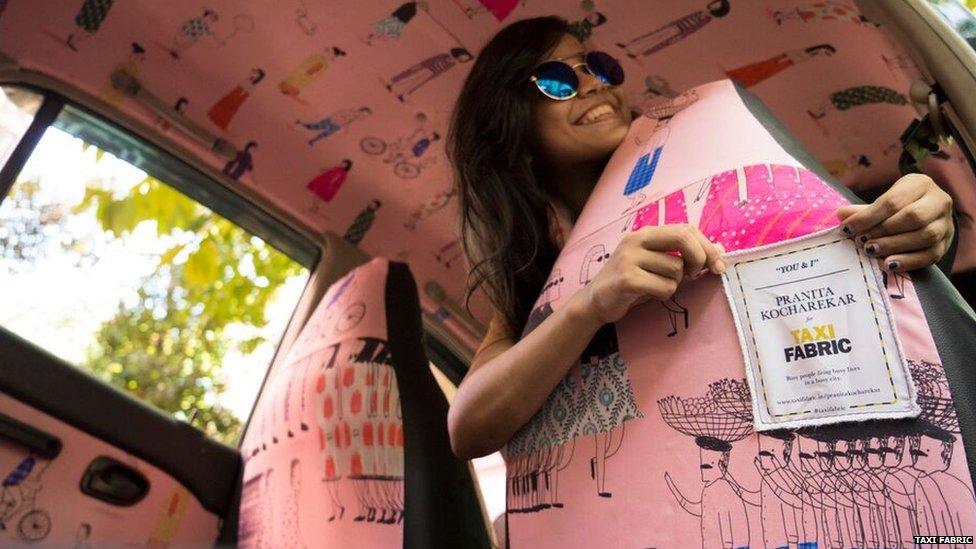 A woman touching a label on a taxi seat