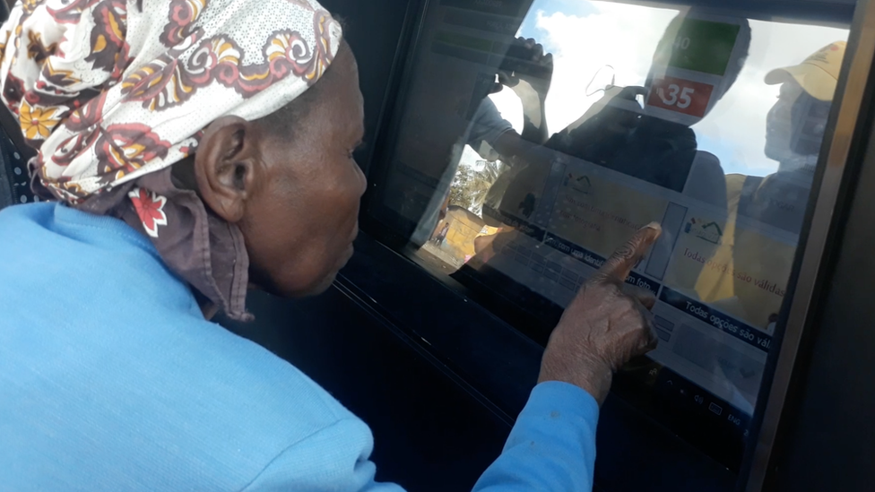 Woman using the community tablet