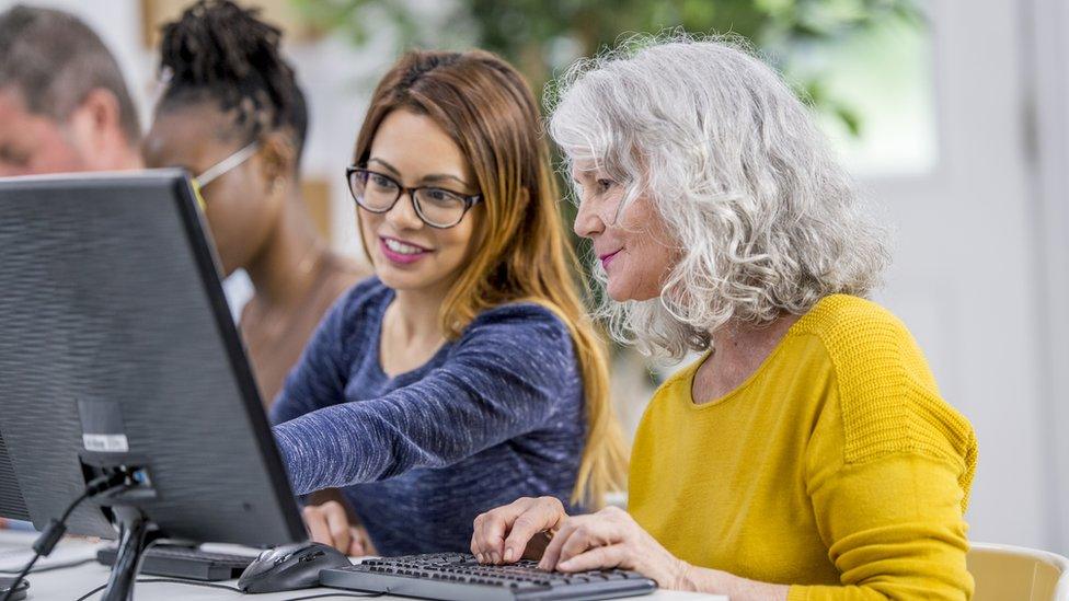 A older woman at a computer