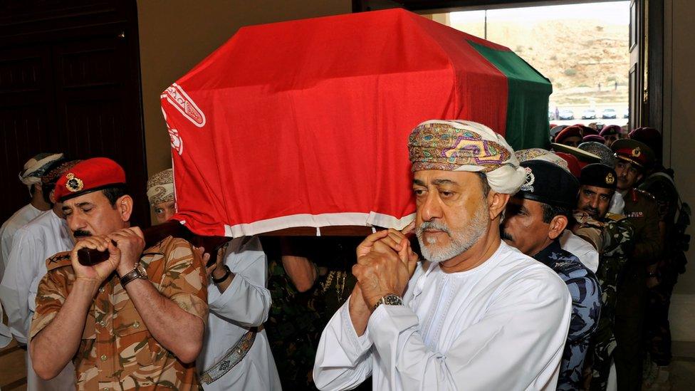 Oman's newly sworn-in Sultan Haitham bin Tariq al-Said carries the coffin of his cousin, the late Sultan Qaboos