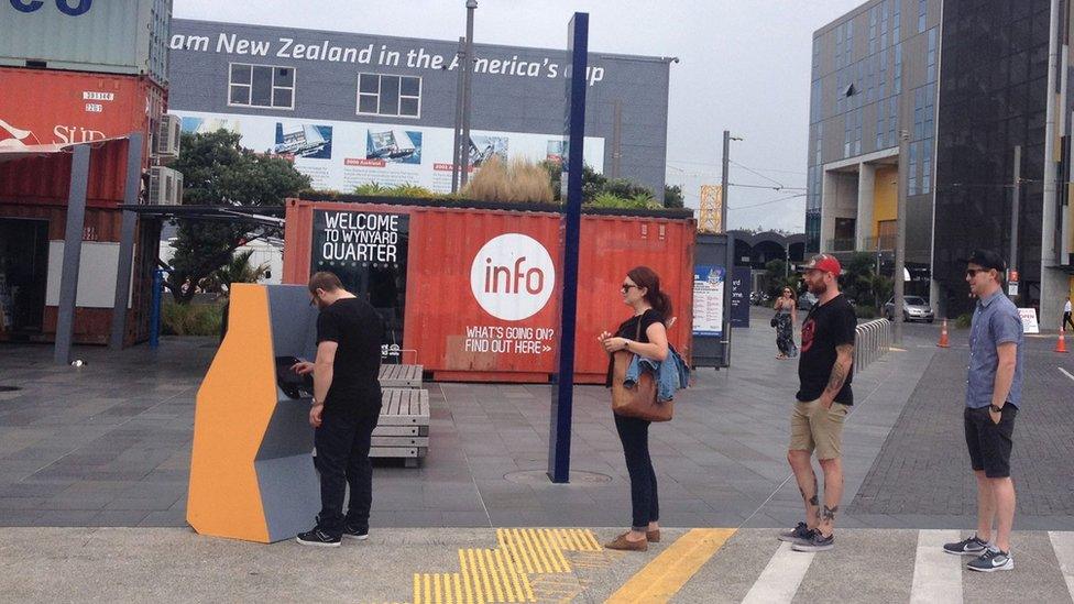 People using a Moodbank "cash" machine in Auckland, New Zealand.