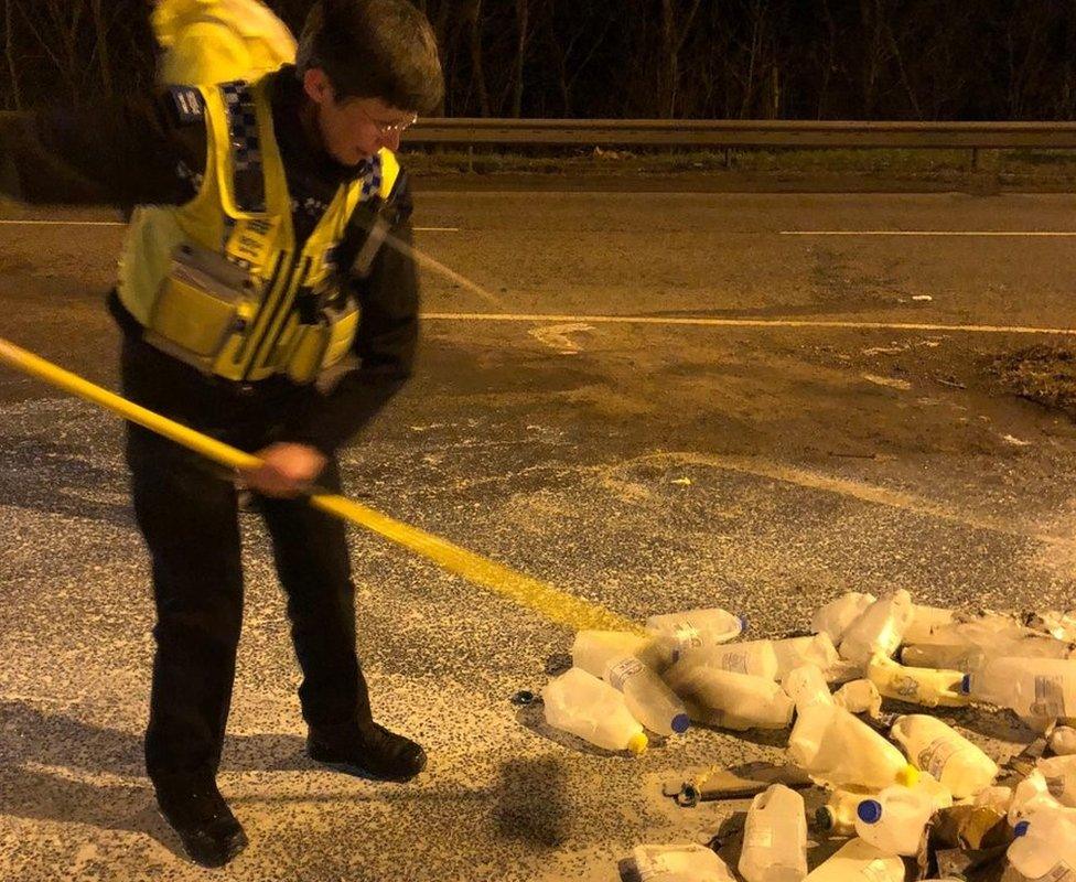 Police officer clears up milk